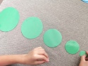 Dziecko układa zielone koła od największego do najmniejszego – nauka porządkowania według rozmiaru
